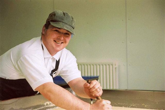 Justin cutting a vat of curd